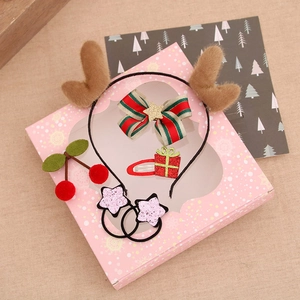 Christmas hair accessories gift set with reindeer antlers and bows in a pink window box
