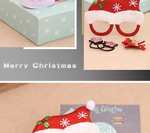 Detailed view of Christmas accessory set with glitter glasses, star hairpins, and festive box