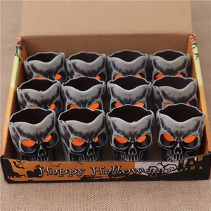Set of 12 Halloween skull LED tea lights in a themed gift box for party decoration