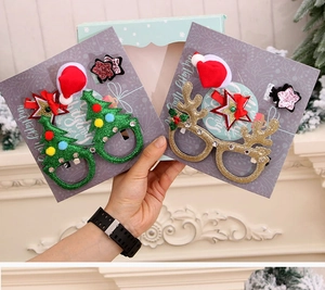 Close-up of Christmas festive glasses and hairpins in a light blue holiday gift box