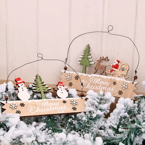 Wooden Merry Christmas hanging sign with snowman and reindeer decor on light wood background