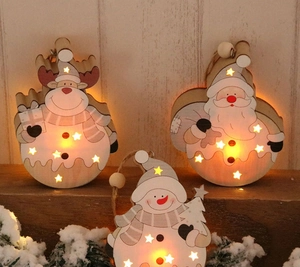 Detailed view of glowing wooden Christmas ornaments with warm LED lights and star cutouts