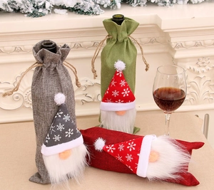 Detail view of 3-piece burlap Christmas gnome wine bottle covers for festive table decor