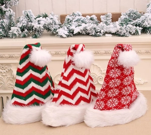 Close-up of three festive knitted Christmas hats with plush pom-poms and winter patterns