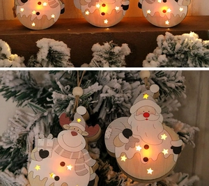 Close-up of lighted wooden Christmas tree pendant with Santa and Reindeer designs