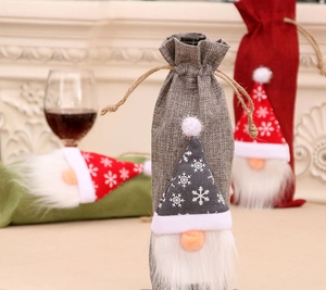 Three-piece gnome Christmas wine bottle covers in grey, red, and green burlap fabric