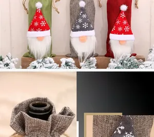 Detail of Christmas gnome wine bottle covers with knitted snowflake hats and faux fur beards