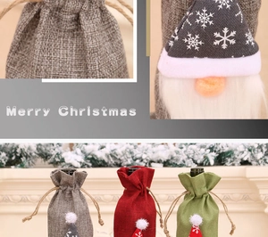 Close-up of burlap Christmas gnome wine bottle bags in red, green and grey colors