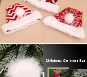 Detail of red knitted Christmas hat featuring white plush ball and festive snowflake patterns