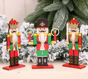 Close-up of three wooden nutcracker soldiers with glitter crowns and fiber beards