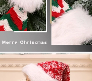 Close-up of knit Christmas hat featuring snowflake patterns and plush pom-pom details