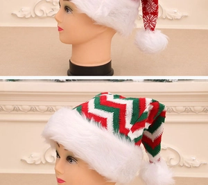 Detail of red snowflake knit Christmas hat and green striped pattern with plush pompom