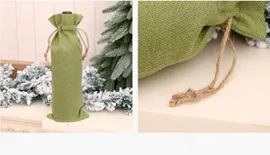Detailed view of a green burlap wine bottle bag with natural jute drawstring for Christmas