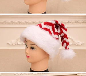 Detail of red and white wave knit Christmas hat with soft faux fur pompom and brim