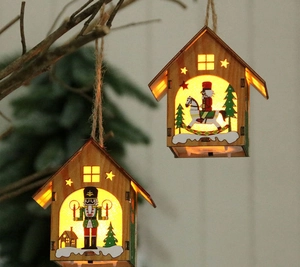 Detail of DIY Christmas wooden houses with warm LED lights and nutcracker carvings