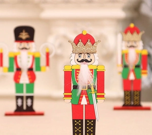 Detailed close-up of three wooden nutcracker soldiers with gold glitter and white fur beard