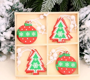 Detailed view of red and green wooden Christmas ornaments in a natural pine storage box