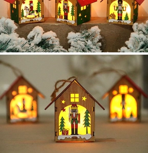 Detailed view of luminous wooden Christmas house with nutcracker design and LED light