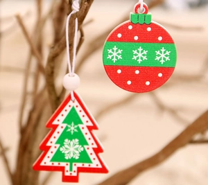 Detailed view of red and green wooden Christmas ornaments with snowflake patterns