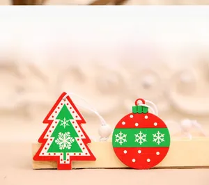 Detail of red and green wooden Christmas tree and ball ornaments with snowflake patterns