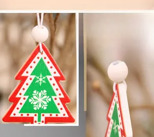 Detail view of a red snowflake pattern wooden Christmas tree ornament with a hanging bead