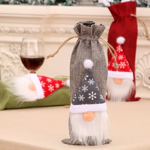 Three Christmas gnome wine bottle covers in grey red and green with snowflake hats