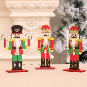 Three wooden Christmas nutcracker soldier figurines with festive red and green paint