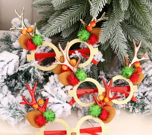 Detail of Christmas reindeer antler glasses with gold sequins and festive decorations