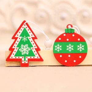 Handcrafted wooden Christmas tree and bauble ornaments with festive snowflake patterns