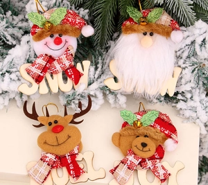 Detailed view of plush Christmas ornaments with wood letters and festive tiny gold bells