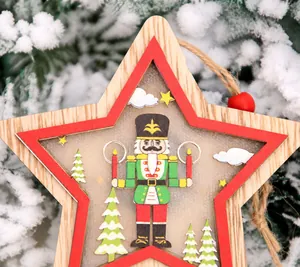 Close-up of star-shaped wooden Christmas ornament with nutcracker soldier and snow pine needles