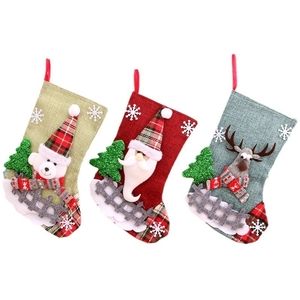 Three linen Christmas stockings with 3D Santa, bear, and reindeer hanging decorations
