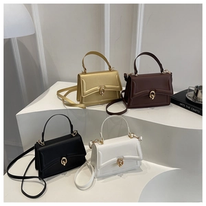 Detail view of four-color matte leather handbags with metal turn-lock closures and straps