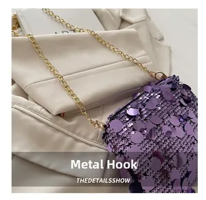 Detail of golden hardware hook and purple sequin texture on trendy chain shoulder bag