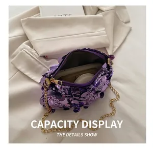 Detailed interior of purple sequin handbag with chain strap showing daily essentials