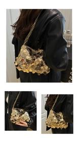 Close-up of golden sequin chain bag with large metallic discs and fine strap detail