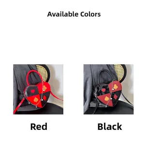 Macro detail of heart-shaped crossbody bags featuring poker card prints in red and black