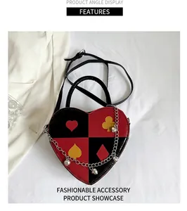 Detail of heart-shaped handbag featuring red and black poker suit patterns and metal chain