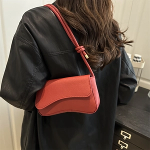 Red retro baguette bag in cross-pattern leather featuring knot shoulder strap detail