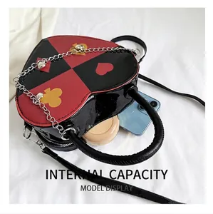 Detail view of heart-shaped handbag capacity with phone and makeup inside