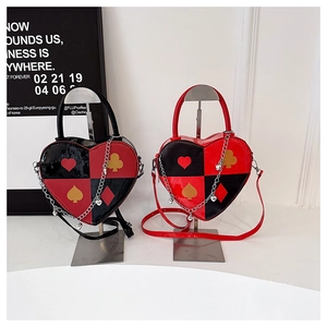 Detail of heart-shaped crossbody bags with poker pattern prints and metallic chain straps