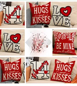 Detail view of linen Valentine's Day cushion covers with red hearts and festive text