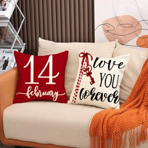 Valentine's Day linen pillow covers with red heart and love text on a cozy sofa