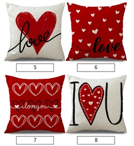 Detail view of four linen Valentine's Day pillow covers with red heart and love patterns