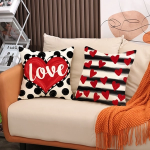 Valentine's Day linen pillow covers with red hearts and love letter prints on sofa
