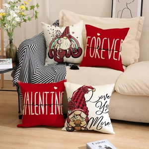 Set of four Valentine's Day linen pillow covers with gnome and heart prints on a sofa