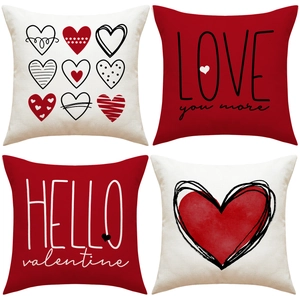 Detail view of four linen Valentine pillow covers with red heart prints and love typography