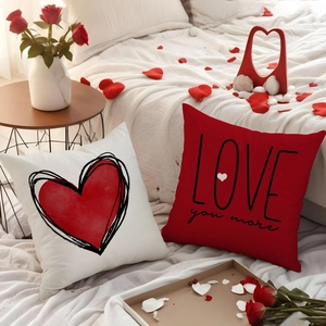 Linen Valentine's Day throw pillows with red hearts and 'Love You More' printed text