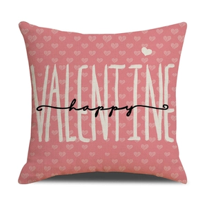 Detail of pink cotton-linen Valentine cushion cover with white hearts and happy text