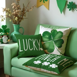 Detailed view of St. Patrick's Day clover pillow covers with Lucky text on a green sofa